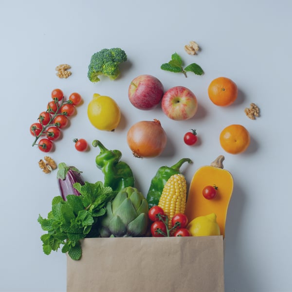 Paper shopping bag full of fruits and vegetables