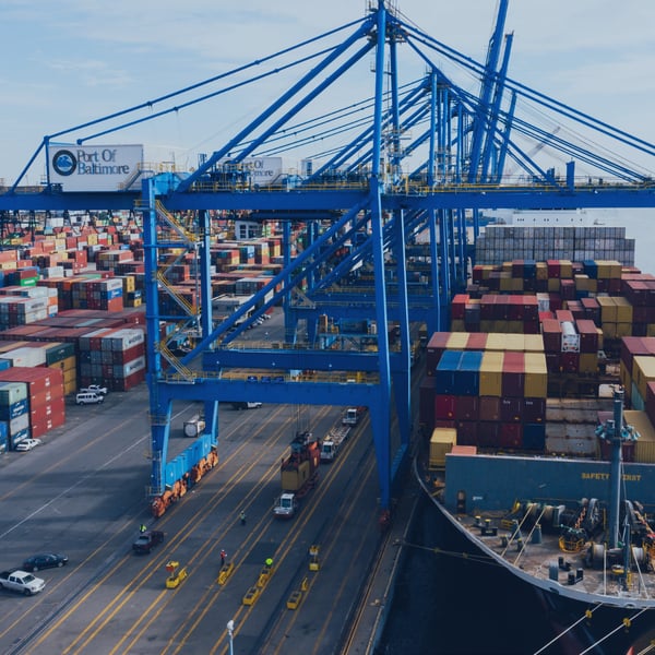 A cargo ship loaded with shipping containers, representing the L&T industry