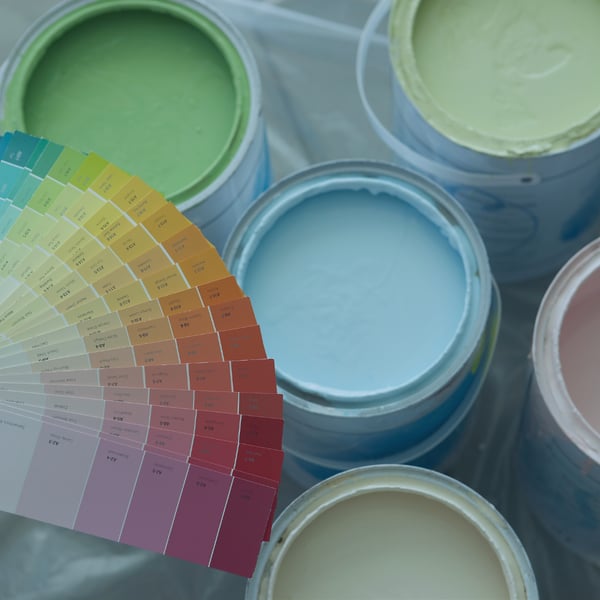 Colorful paint cans and color palette representing paints and coatings